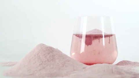Collagen protein powder in glass of water. Food additives. Anti age concept. Stock Footage