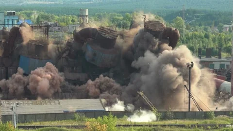 The collapse of an obsolete industrial chimney with an explosion. Disposal of an Stock Footage
