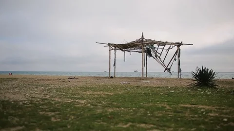 Collapsed awning of bamboo on an abandoned beach. Stock Footage 73223533