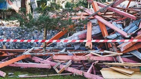 Collapsed building debris with caution tape in urban environment 스톡 사진