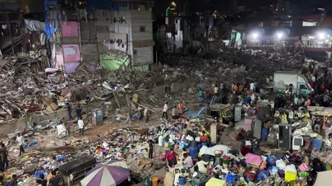 Collapsed building in a dense slum at night. Devastation and destruction Stock Footage 335878177