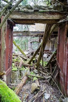 Collapsed Building Interior with Moss and Rubble, View Through Doorway Stock Photos