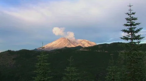 The collapsed caldera of Mount St. Helen's smokes above the Stock Footage