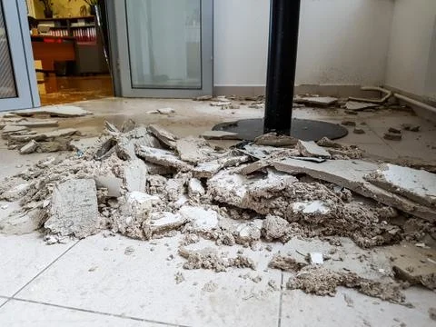Collapsed ceiling panels on the floor. Stock Photos