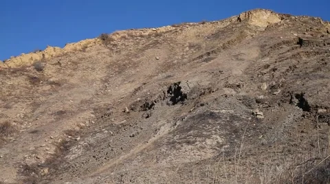 Collapsed hillside that buckled road in Vasquez canyon landslide Stock Footage 57539050