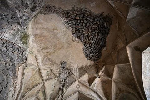Collapsed historic dome ceiling with intricate medieval architecture and we.. Stock Photos