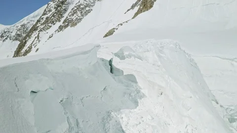 Collapsed hollow and cracks in deep thick snow, mountain slope, avalanche hazard Stock Footage 126365613