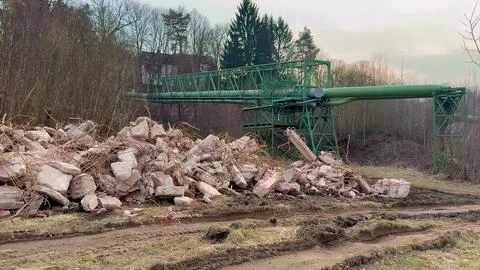A collapsed industrial structure surrounded by debris and heavy machinery s.. Foto stock