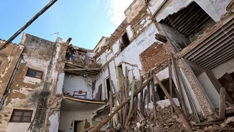 Collapsed multi-story building ruins under bright sky Stock Footage 339791603
