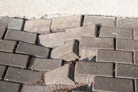Collapsed pavement on the sidewalk, worn out road structures Stock Photos