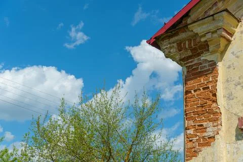 Collapsed plaster on the facade of an old red brick building. The facade of t Stock Photos