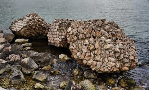 Collapsed wall sea Stock Photos