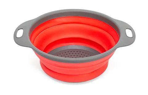 Collapsible silicone colander red kitchenware draining vegetables Stock Photos