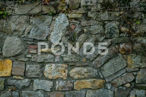 The collapsing stone arch is laid with bricks to protect against the destruct Stock Photos