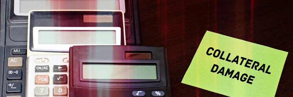 COLLATERAL DAMAGE message card next to three calculators. Stock Photos