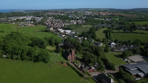 Collaton St Mary, South Devon, England: DRONE VIEWS: St Mary church and village Stock Footage 242486365