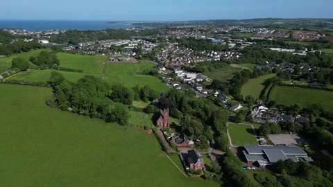 Collaton St Mary, South Devon, England: DRONE VIEWS: St Mary Church and village Stock Footage 242488118
