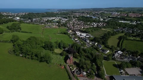 Collaton St Mary, South Devon, England: DRONE VIEWS: St Mary Church and village Stock Footage 242488139