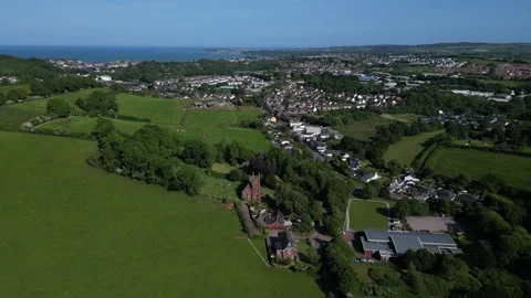 Collaton St Mary, South Devon, England: DRONE VIEWS: The village, church &amp; sea Stock Footage 242488784