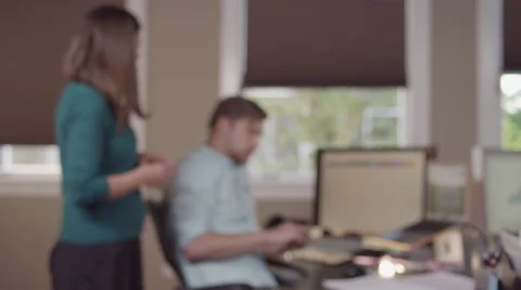Colleages gathered around a computer in a bright office and reading charts Stock Footage 55349842