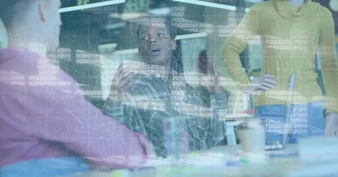 Colleague analyzing projected code on glass partition in office, holding white Foto stock