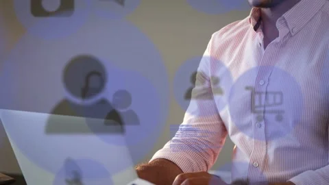 Colleague handing tablet initiating tech app overlay, seated man at laptop Stock Footage 335235486