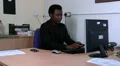 Colleague places folder on mans desk to his dislike HD Footage