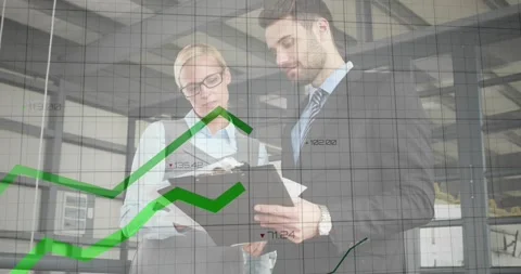 Colleagues analyzing finance docs as camera pullback overlaying finance grid and Stock Footage 331570944