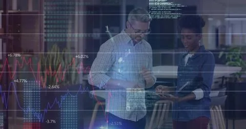 Colleagues analyzing financial data on tablet at high table in office, with data Stock Photos