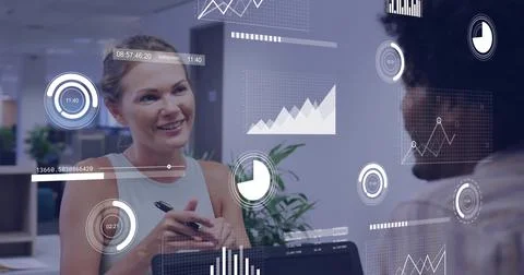 Colleagues analyzing floating data visualizations in modern open-plan office, Stock Photos