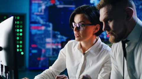 Colleagues analyzing security data on computer 스톡 사진