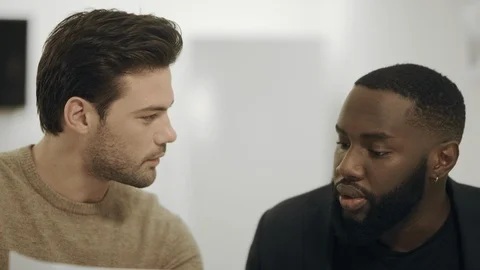 Colleagues analyzing working data together. Young workers comparing information Stock Footage 113278828