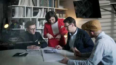 Colleagues And Clients Talking Strategy With Project Magazine. In Creative Stock Footage 132848280