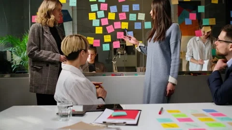 Colleagues And Clients Talking Strategy With Laptop And Tablet. In Creative Offi Stock Footage 167070175