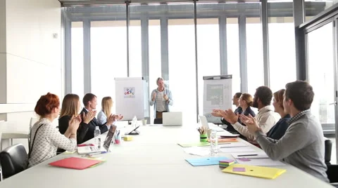 Colleagues applauding creative director during a meeting Stock Footage 59544074