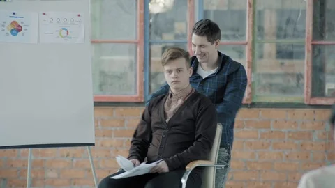 Colleagues are fooling around. One turns the other in an office chair. Coworking Stock Footage 124548867