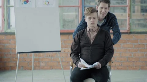Colleagues are fooling around. One rolls the other in a chair around the office Stock Footage 124549029