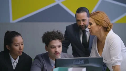 Colleagues around the computer, discuss work, sharing ideas, brainstorm Stock Footage 233717305