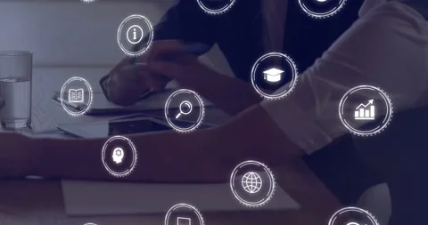 Colleagues bringing hands, noting on pad while tapping tablet, icons framing Stock Footage 331270015