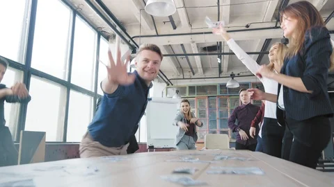 Colleagues celebrate the end of the project, fun dancing near the table and Stock Footage 108376260