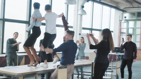 Colleagues celebrate the end of the work week, have fun dancing on the table Stock Footage 108368324