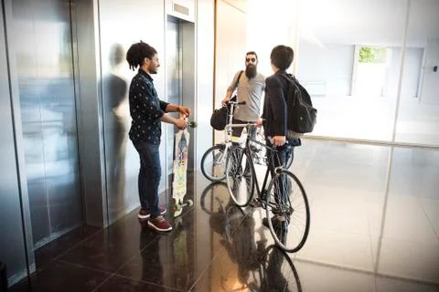 Colleagues chatting in lobby Stock Photos