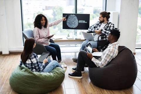 Colleagues collaborating on an artificial intelligence project in casual room 스톡 사진