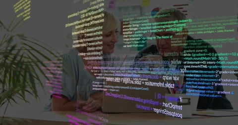 Colleagues collaborating at desk while tracing code on laptop as lines appearing Stock Footage 317599934