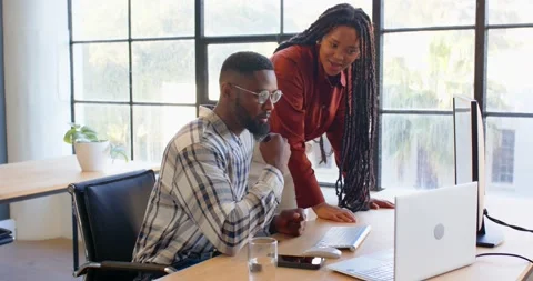 Colleagues collaborating at office desk, analyzing data on computer screen Stock Footage 345653814