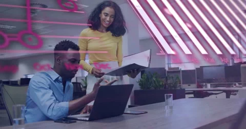 Colleagues collaborating in office, showcasing digital code overlay animating Stock Footage 308571631