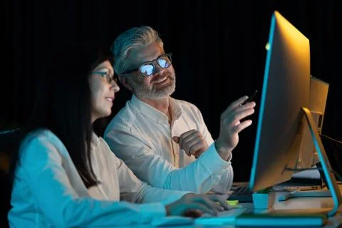 Colleagues Collaborating on Project at Computer Screen in Office Stock Photos