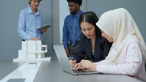 Colleagues Collaborating on Project in Modern Office Video stock 286072530