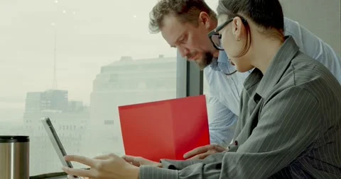 Colleagues Collaborating on Project in Modern Office 스톡 동영상 323576898