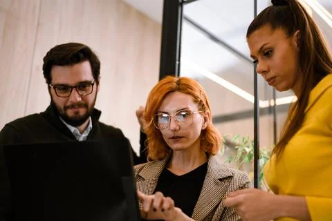 Colleagues collaborating on a project in a modern office setting during the day Stock Photos